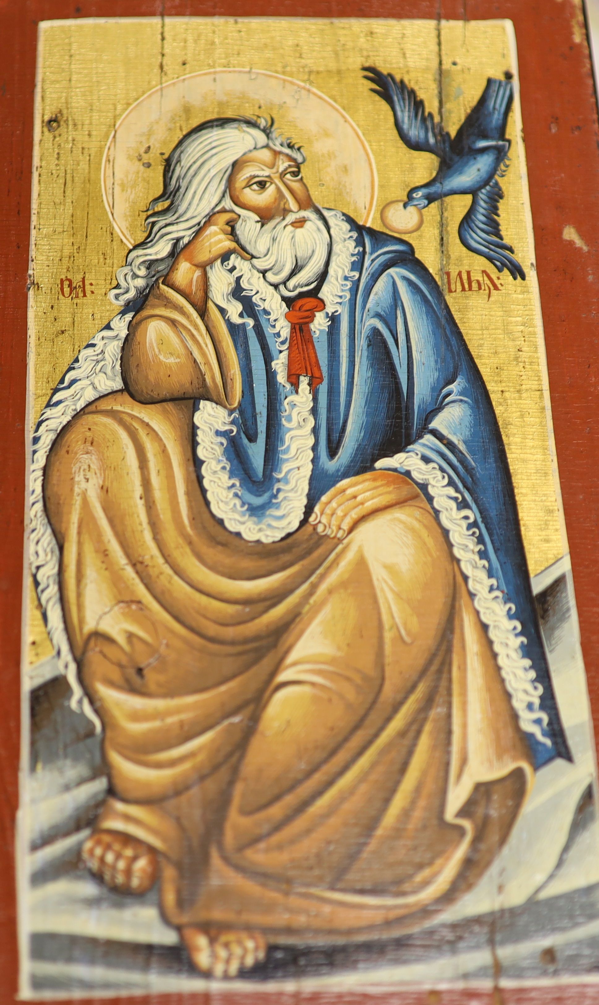 A modern oil on panel Icon of a seated saint, 40 x 21.5cm.